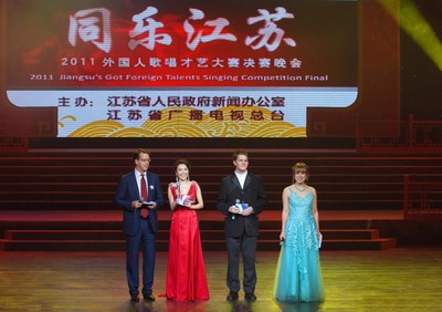 Managing Director of Ignite Media Group, Mark Hammons (far left), stands with the other hosts, Jade Wang, Zhou Gen-sheng and Tang Ya.